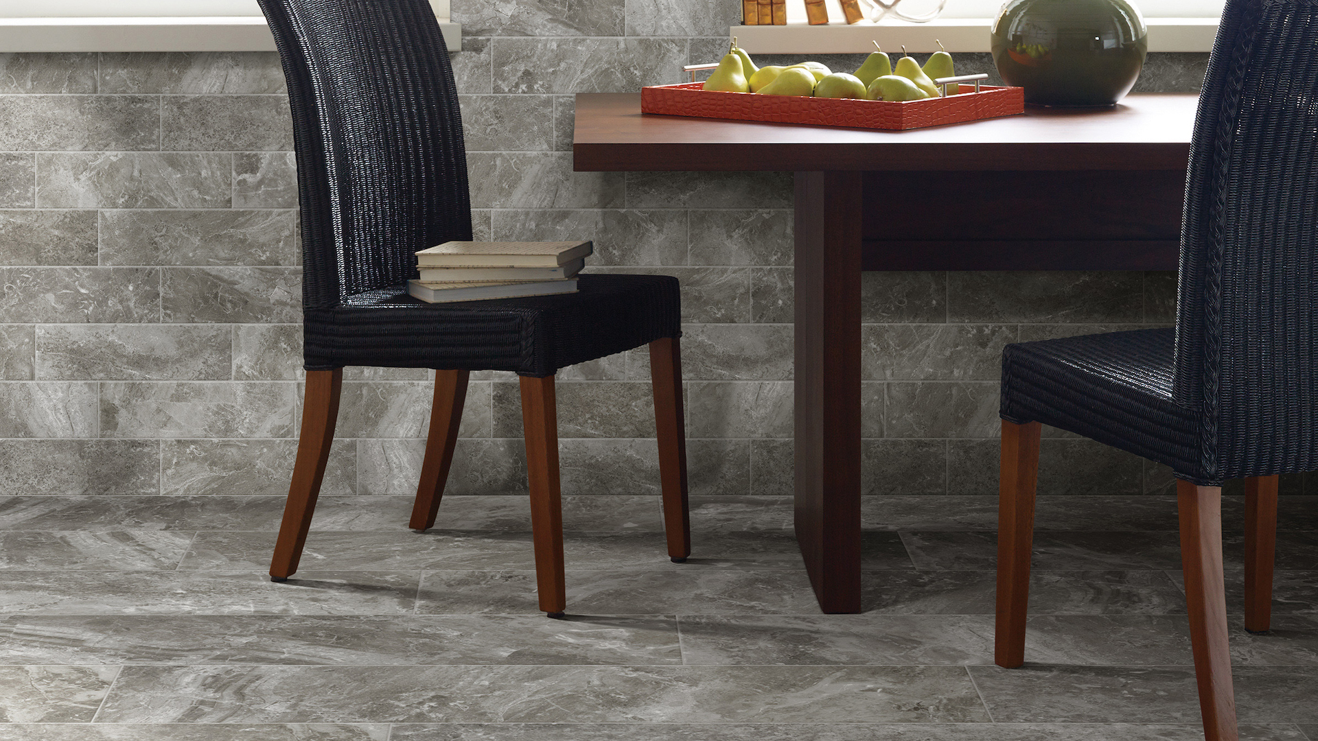 grey commercial tile flooring in a sitting area with blue upholstered chairs and a wooden side table